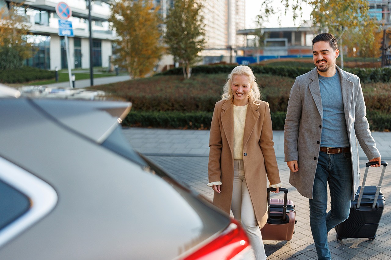 two business traveller walking to their car rental